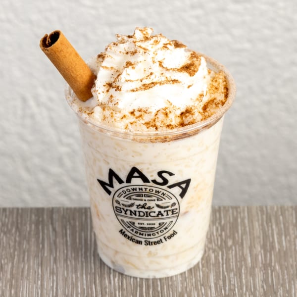 Horchata drink from Masa Downtown with whipped cream, cinnamon powder, and a cinnamon stick.
